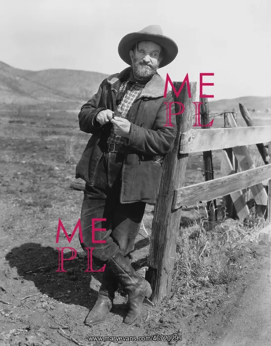  : Man leaning against fence post