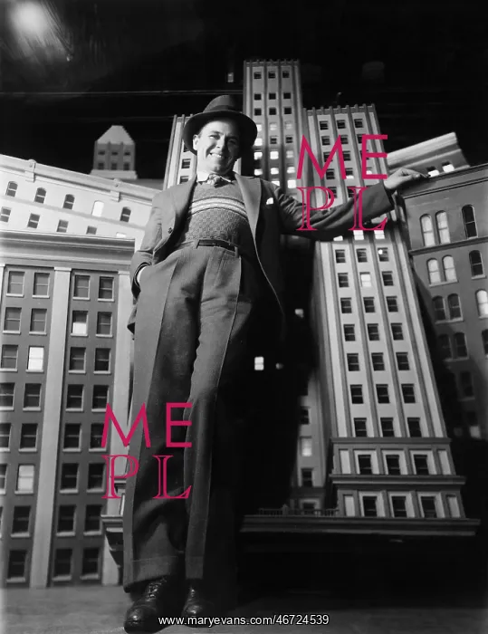  : Man leaning against model buildings