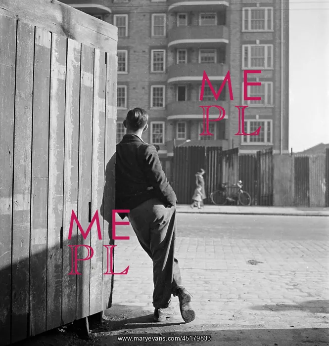 : Man leaning on street corner : Man leaning on street corner