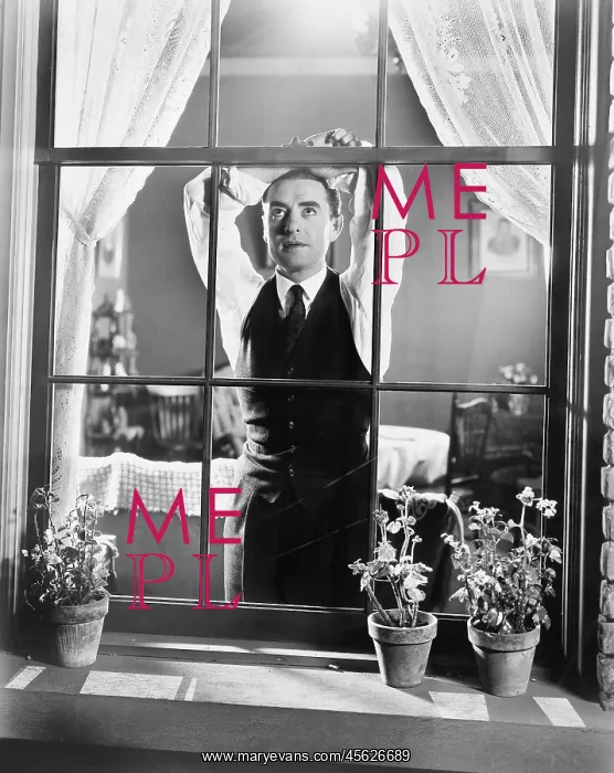 : Man leaning against a window while day dreaming : Man leaning against a window while day dreaming
