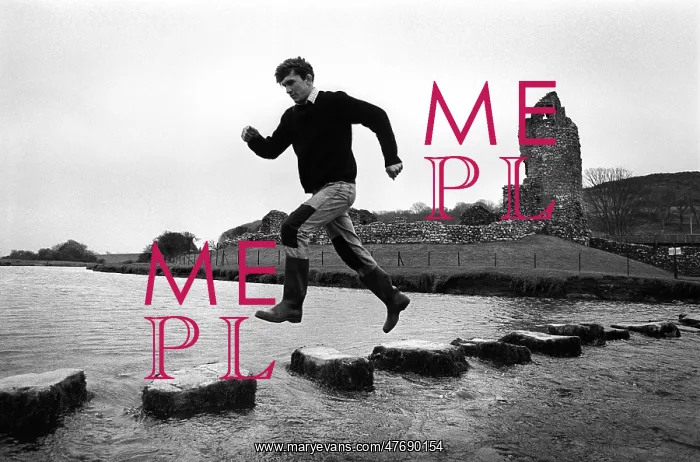 : A man leaps along the stepping stones at Ogmore Castle : A man leaps along the stepping stones at Ogmore Castle