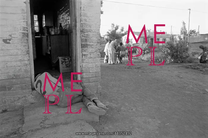 : Man lies in the doorway of his home : Man lies in the doorway of his home