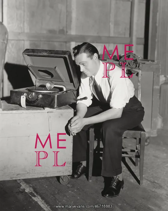 : Man listening to portable gramophone : Man listening to portable gramophone