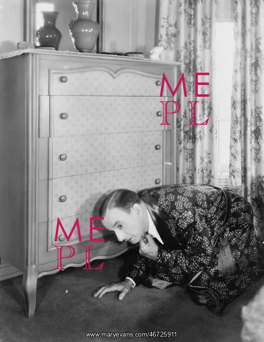  : Man looking for something under the dresser