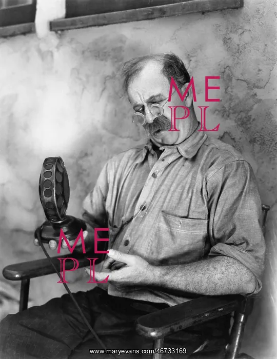 : Man looking at a microphone : Man looking at a microphone
