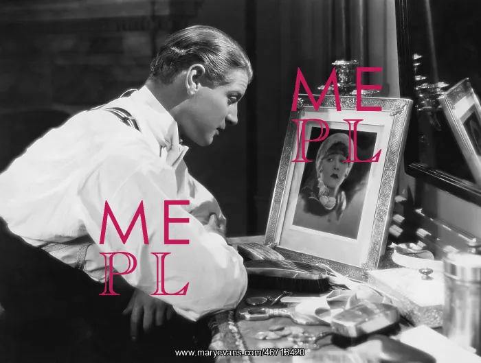: Man looking at portrait of woman : Man looking at portrait of woman