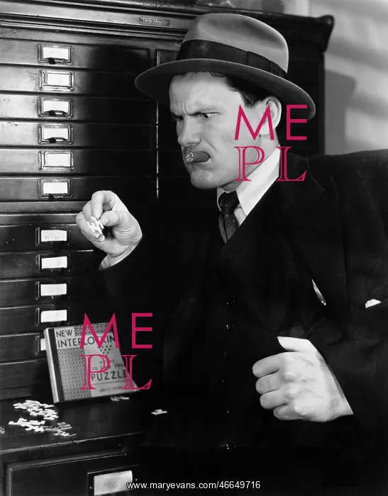  : Man looking sternly at a piece of puzzle