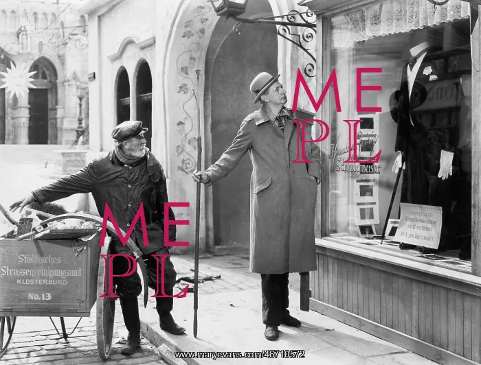  : Man looking at a window display of a tuxedo