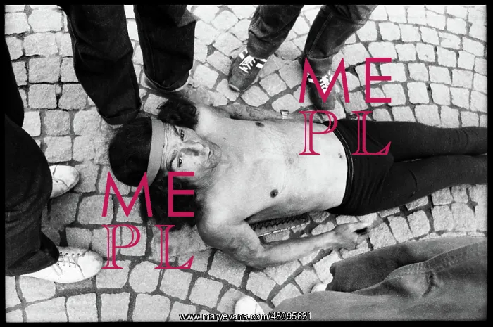  : Man lying on bed of nails - street performer, Paris, France