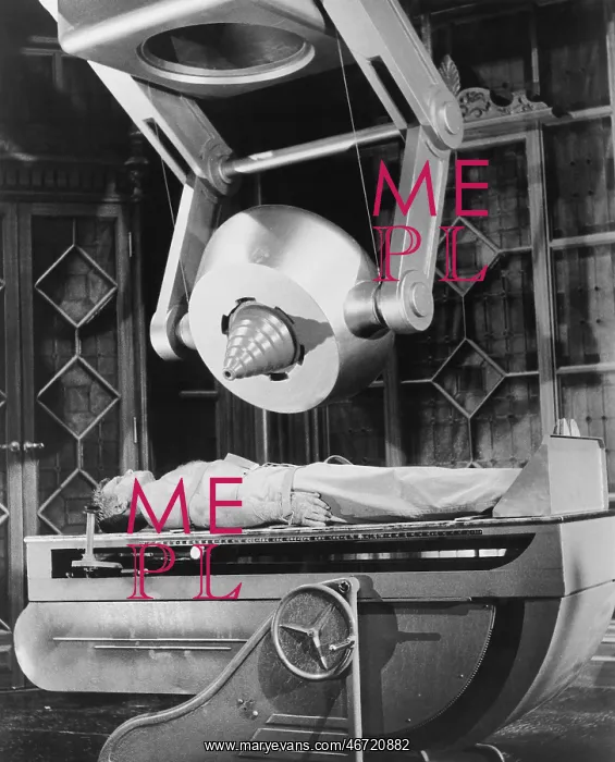 : Man lying below huge machine : Man lying below huge machine