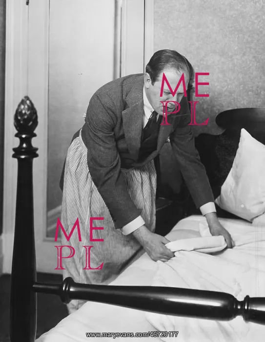  : Man making bed