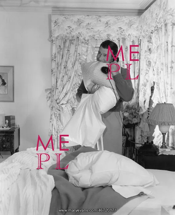 : Man making bed and talking on phone : Man making bed and talking on phone