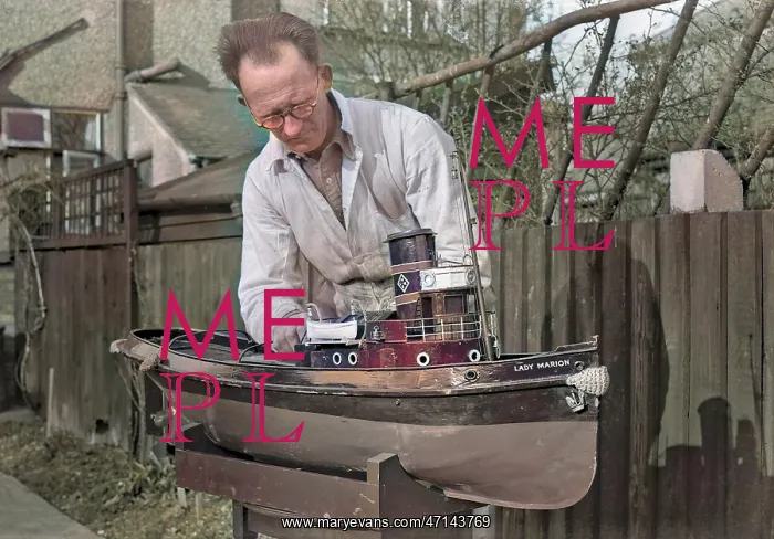 : Man making model boat in garden : Man making model boat in garden
