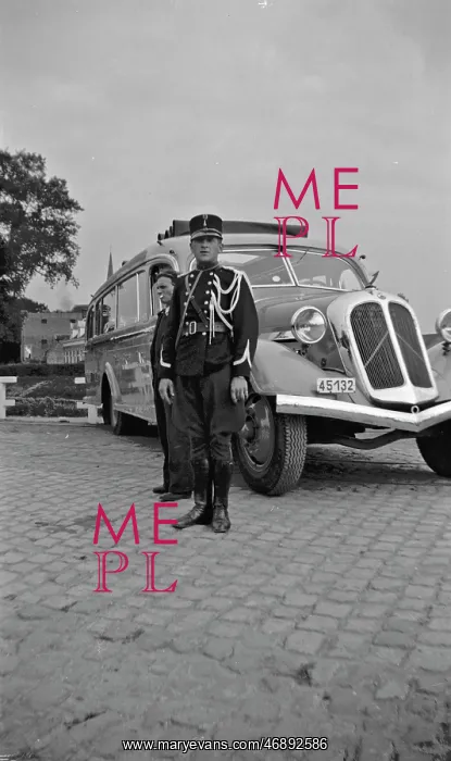 : Man in military uniform standing by a coach : Man in military uniform standing by a coach
