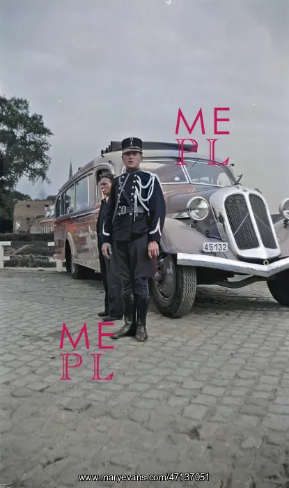 : Man in military uniform standing by a coach : Man in military uniform standing by a coach
