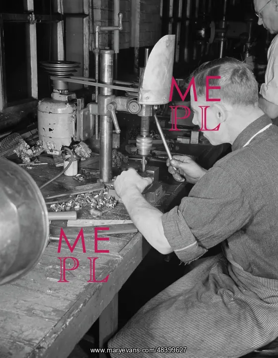 : Man operating a drill press making vital parts : Man operating a drill press making vital parts