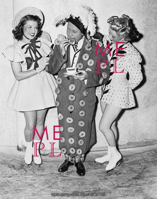 : Man in an outfit made of donuts standing between : Man in an outfit made of donuts standing between