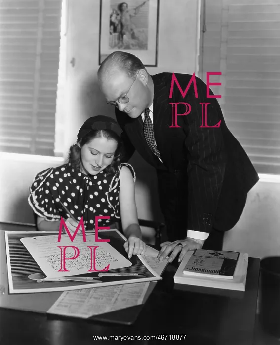 : Man overseeing woman signing document : Man overseeing woman signing document