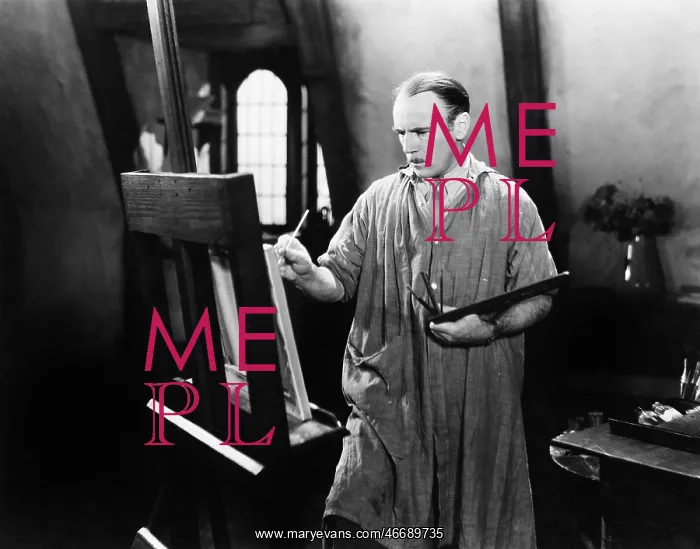 : Man painting on an easel with a paintbrush : Man painting on an easel with a paintbrush