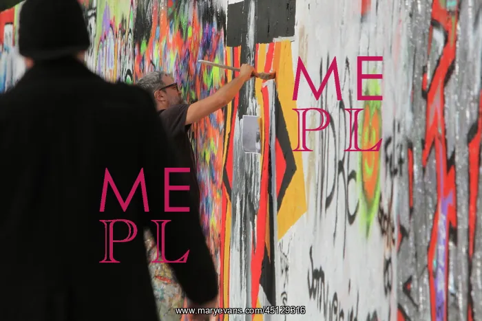 : Man painting on wall, Mauerpark, Berlin, Germany : Man painting on wall, Mauerpark, Berlin, Germany