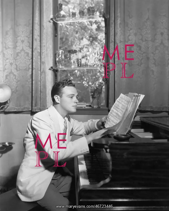 : Man at piano with sheet music : Man at piano with sheet music