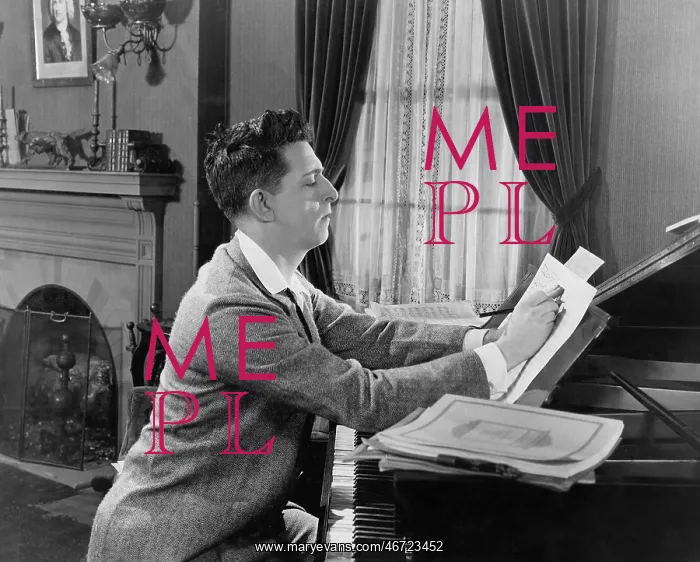  : Man at piano writing on sheet music