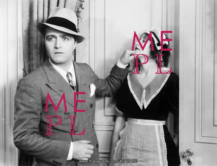 : Man pinching the chin of a housekeeper : Man pinching the chin of a housekeeper