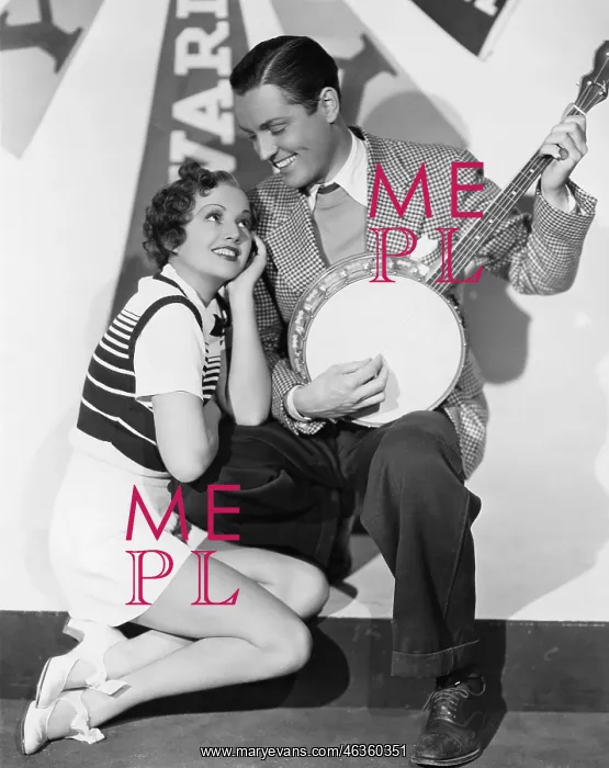 : Man playing banjo for adoring woman : Man playing banjo for adoring woman