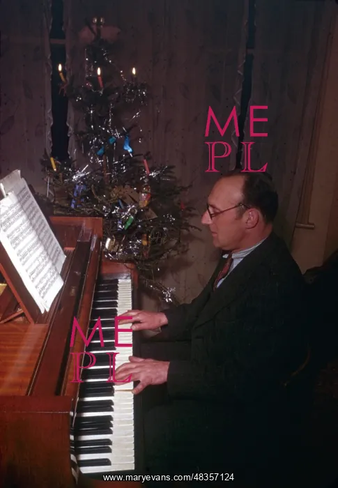 : Man playing piano at Christmas : Man playing piano at Christmas
