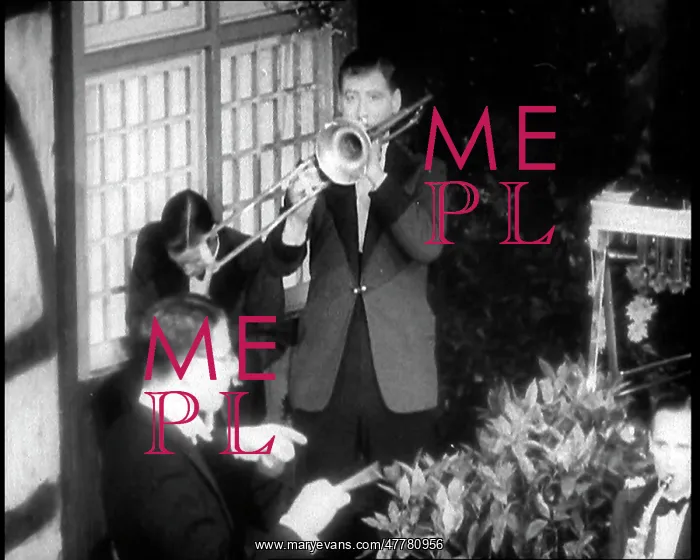 : Man Playing the Trombone Next to a Jazz Band : Man Playing the Trombone Next to a Jazz Band
