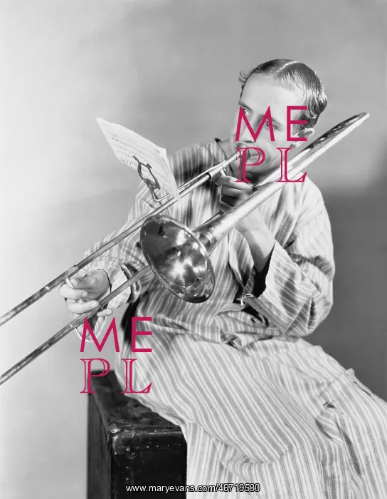 : Man playing trombone in nightgown : Man playing trombone in nightgown