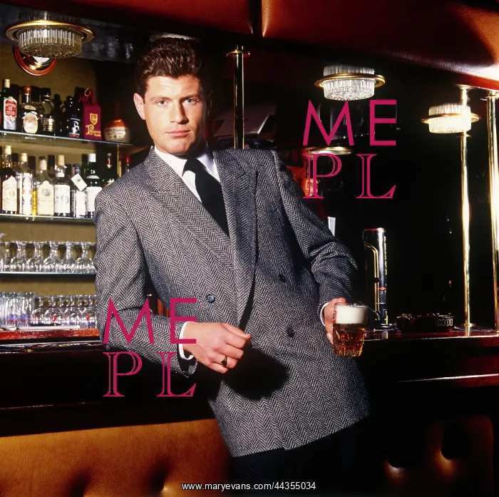 : Man posing in a grey jacket in a bar : Man posing in a grey jacket in a bar