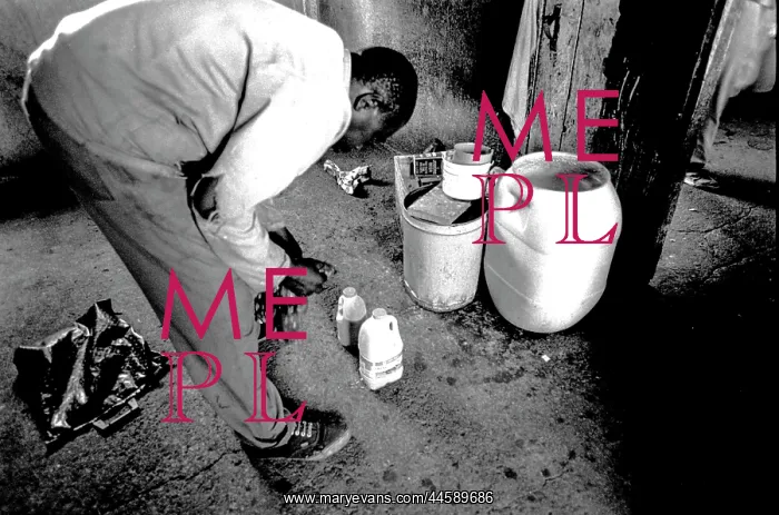  : Man pours beer in a shebeen in Dobsonville