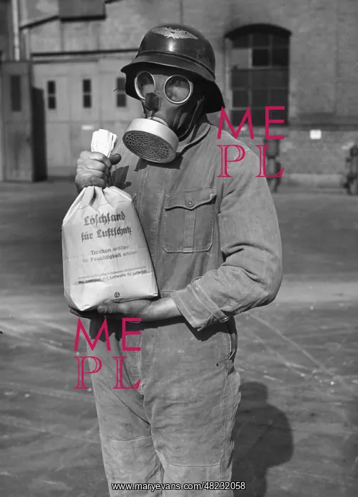 : Man in protective clothing with fire extinguishing sand : Man in protective clothing with fire extinguishing sand