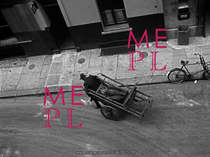 : A man pulls a barrow in Marshall Street, London : A man pulls a barrow in Marshall Street, London