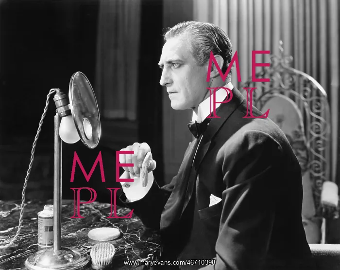 : Man putting powder onto his face in front of a mirror : Man putting powder onto his face in front of a mirror