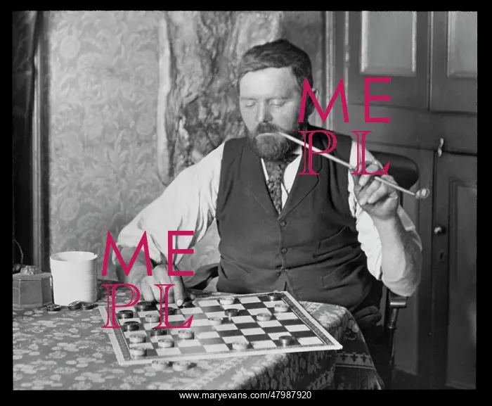 : Man puzzling over a game of draughts : Man puzzling over a game of draughts