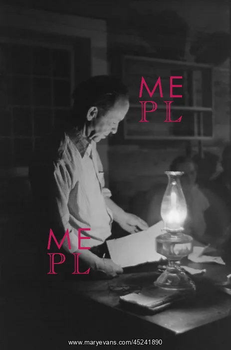  : Man reading by the light of a kerosene lantern. ?