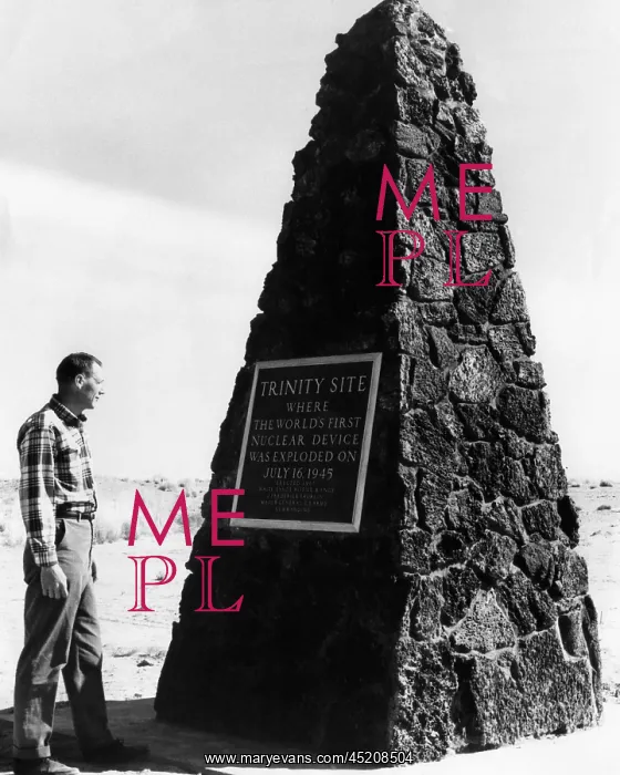 : A man reading the plaque on a monument at ? : A man reading the plaque on a monument at ?