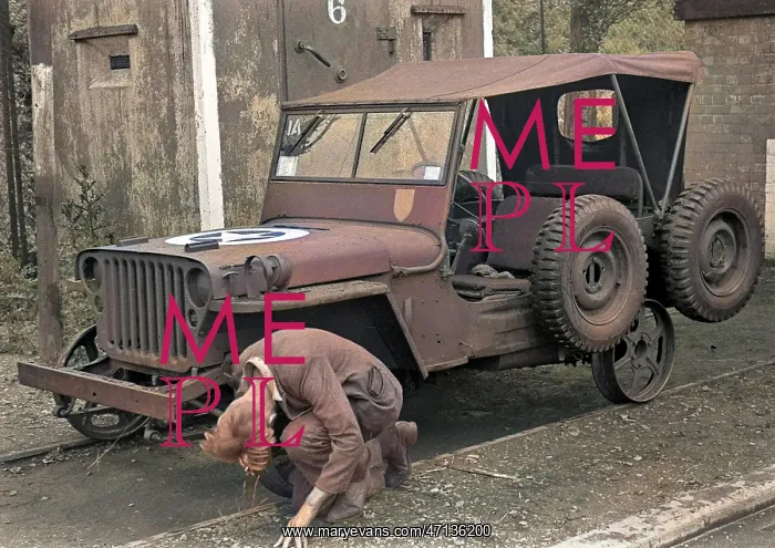  : Man repairing a jeep