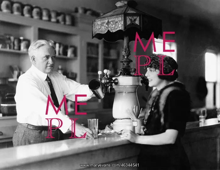 : Man serving beverage to woman at counter : Man serving beverage to woman at counter