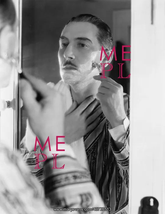  : Man shaving in front of mirror