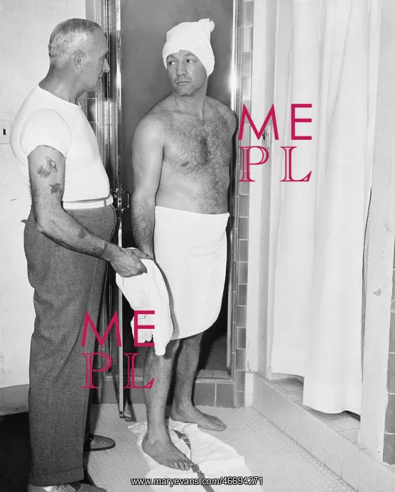 : One man about to shower and one attendant in a bathroom : One man about to shower and one attendant in a bathroom