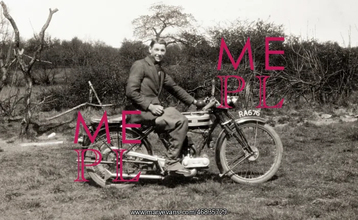 : Man sitting on his 1925 Triumph 500 motorcycle : Man sitting on his 1925 Triumph 500 motorcycle