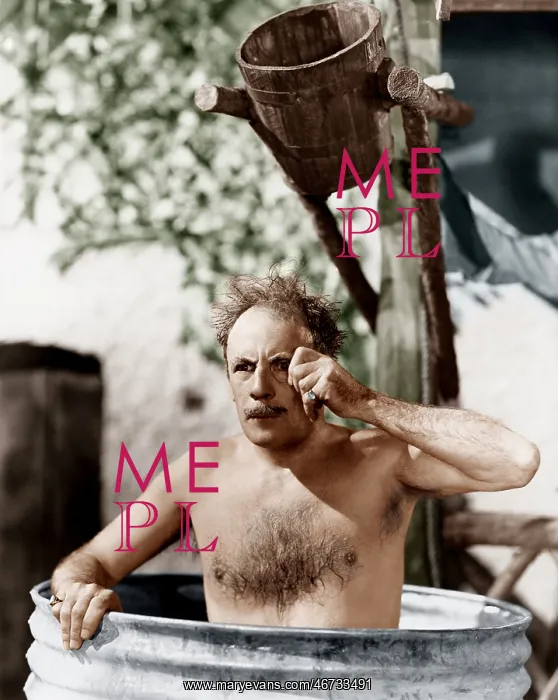 : Man sitting in a barrel taking a bath and looking : Man sitting in a barrel taking a bath and looking