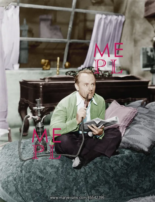 : Man sitting on a bed smoking his water pipe : Man sitting on a bed smoking his water pipe