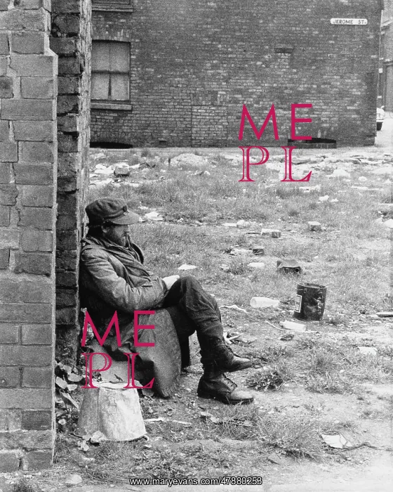 : Man sitting in cleared area - Manchester 1965 : Man sitting in cleared area - Manchester 1965