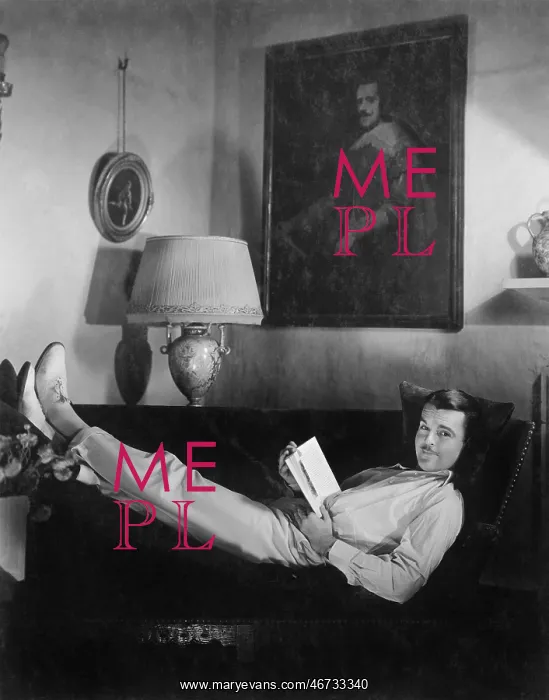  : Man sitting on a couch reading a book