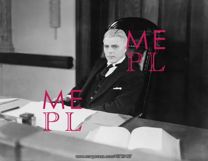 : Serious man sitting at desk : Serious man sitting at desk