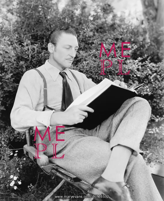 : Man sitting in his garden reading a book : Man sitting in his garden reading a book